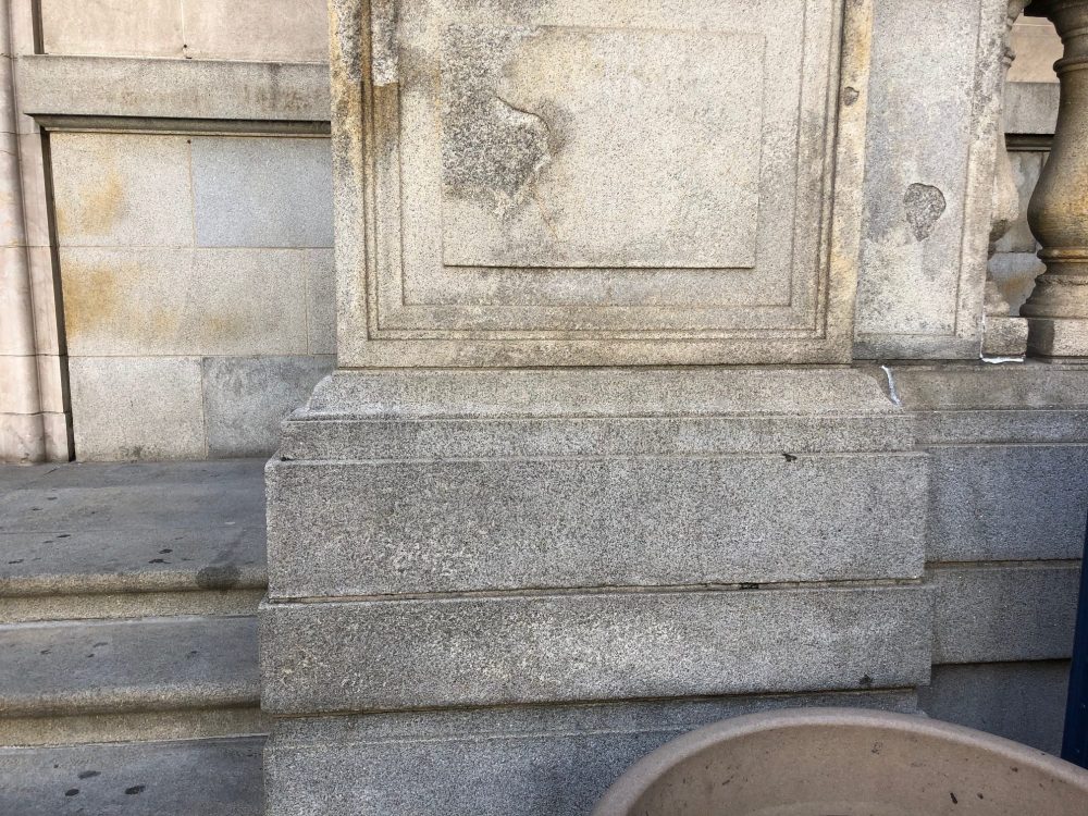 historic building with damaged exterior from improper graffiti removal